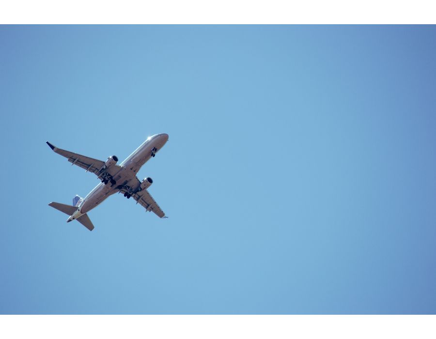 plane flying in blue skies