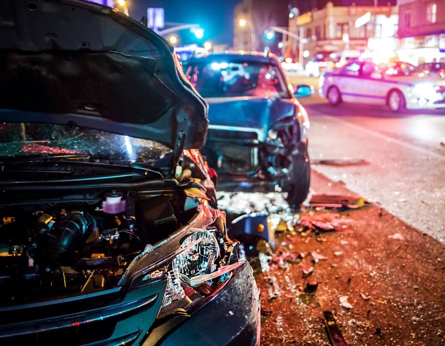 car wreck at night with debris on road