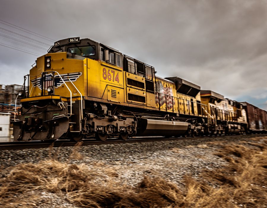 worker train speeding past a city