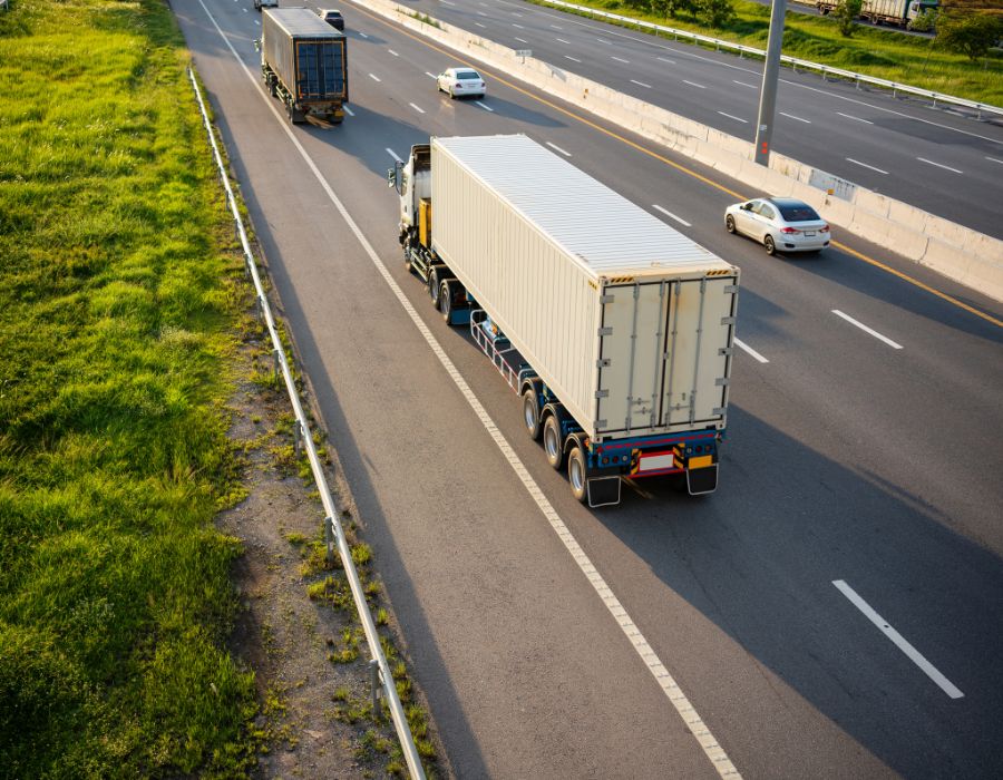 delivery trucks driving down interstate