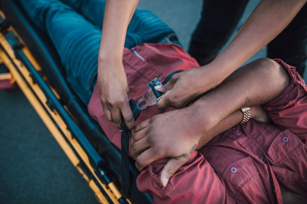 injured victim being secured to stretcher