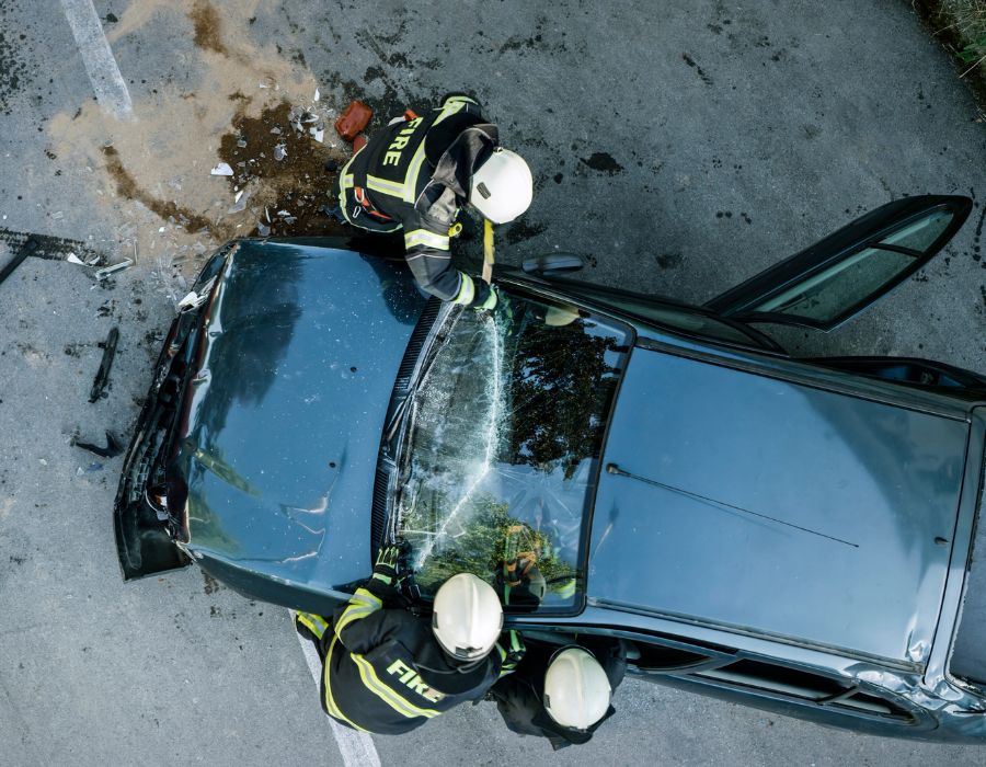 fire department tending to vehicle after a severe crash