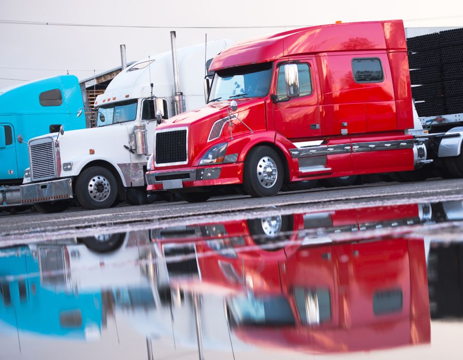 red, white, & blue big rigs on a lot